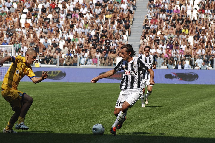 Juventus vs Parma, September 11, 2011: team huddle, player introductions, Antonio Conte coaching from the sideline, Pirlo and Del Piero in action, and Juventus players celebrating a goal during the opening match at Juventus Stadium.