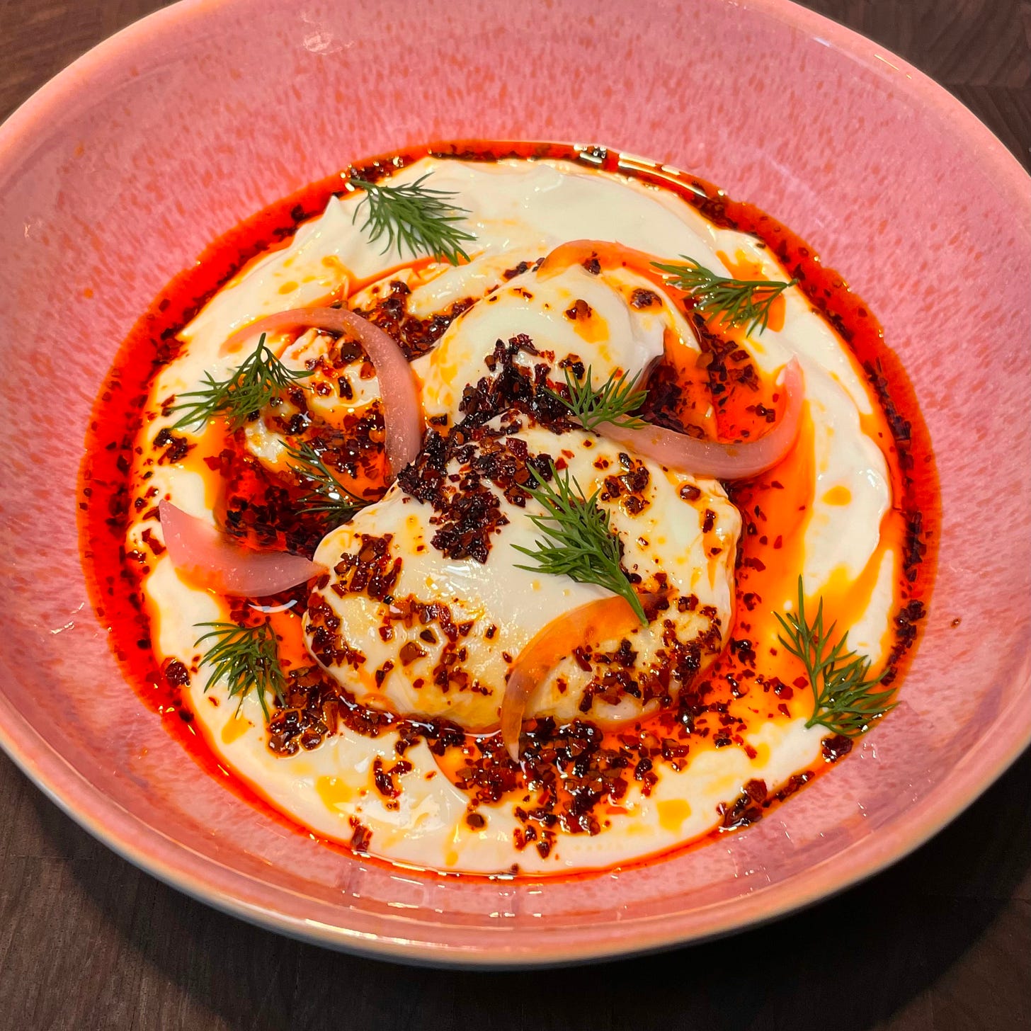 yogurt with poached eggs, doused in chili oil yogurt with poached eggs, doused in chili oil