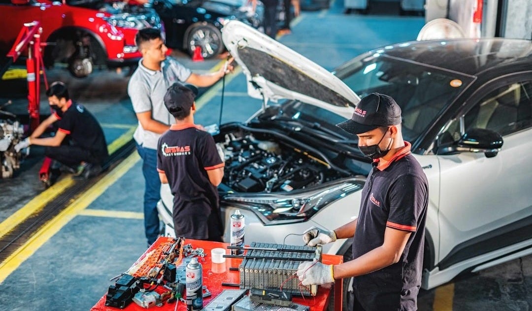 A group of men working on a car in a garage
