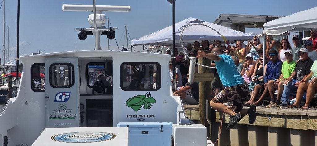 Captain Jake Jacobs leaps from Outlaw during the Taylor’s Island Boat Docking Contest.