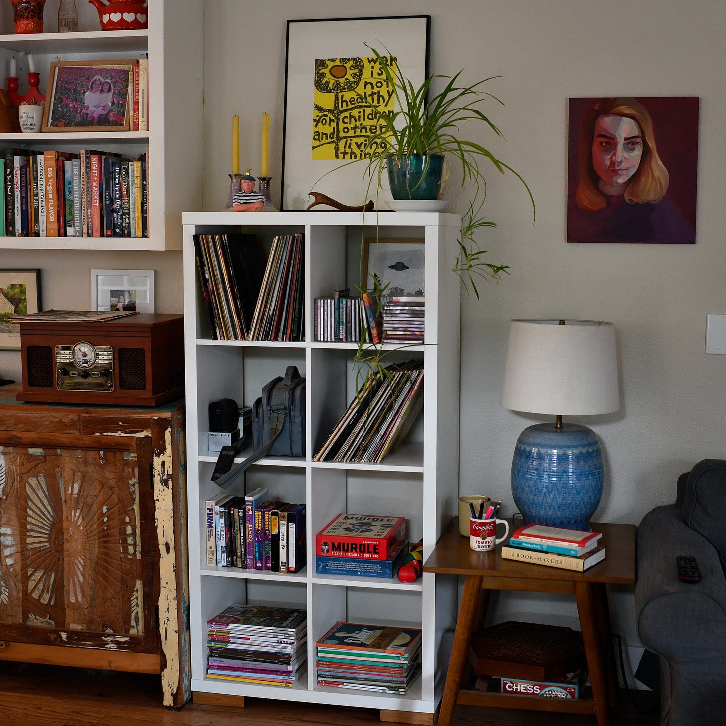 living romm scene with white shelving unit filled with records and other 90s media