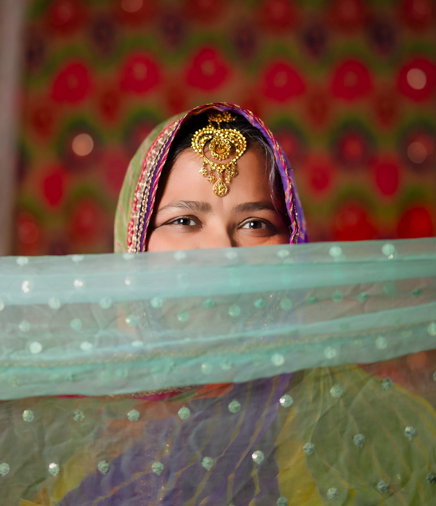 Author Noreen Mughees is pictured in a colorful hijab and scarf with gold jewelry and smiling eyes. Mughees is the author of the Muslim romance 'The Mis-Arrangement of Sana Saeed' Author Noreen Mughees is pictured in a colorful hijab and scarf with gold jewelry and smiling eyes. Mughees is the author of the Muslim romance 'The Mis-Arrangement of Sana Saeed'
