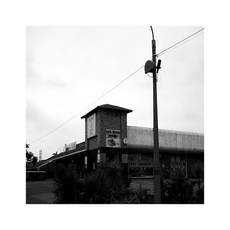 Two chevron boards, A business sign and blurred lights in a restaurant.