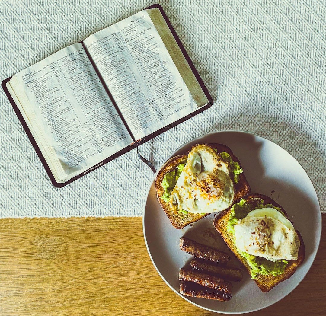 a plate of food and a book on a table a plate of food and a book on a table