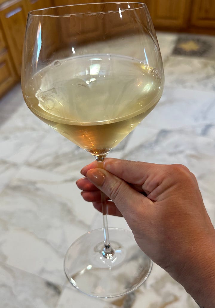 photo of green wine bottle with Domain Ortola label and photo of wine glass filled with white wine