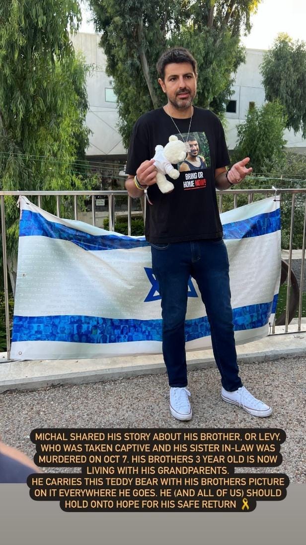 A person standing in front of a flag

Description automatically generated