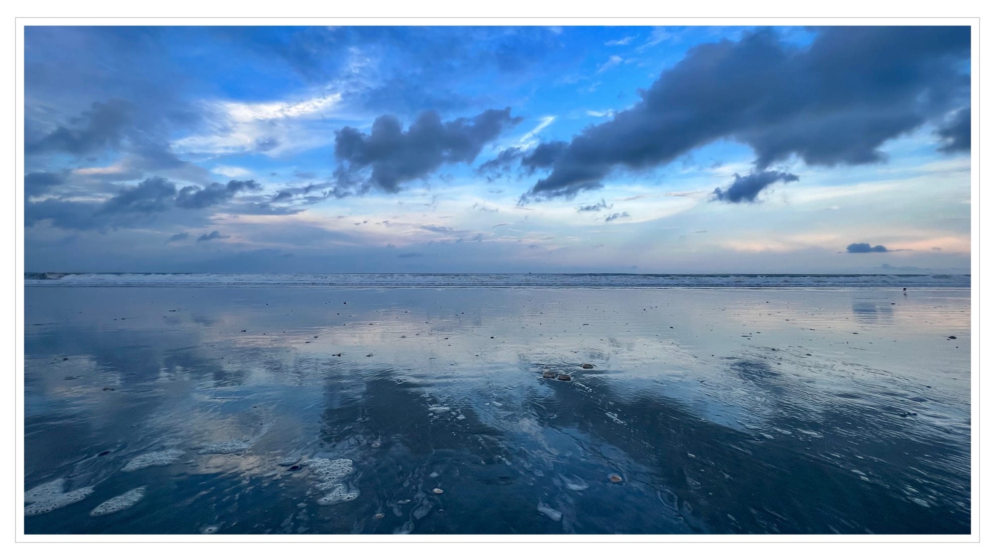 sky relfected in surf, calm ocean waters, twilight