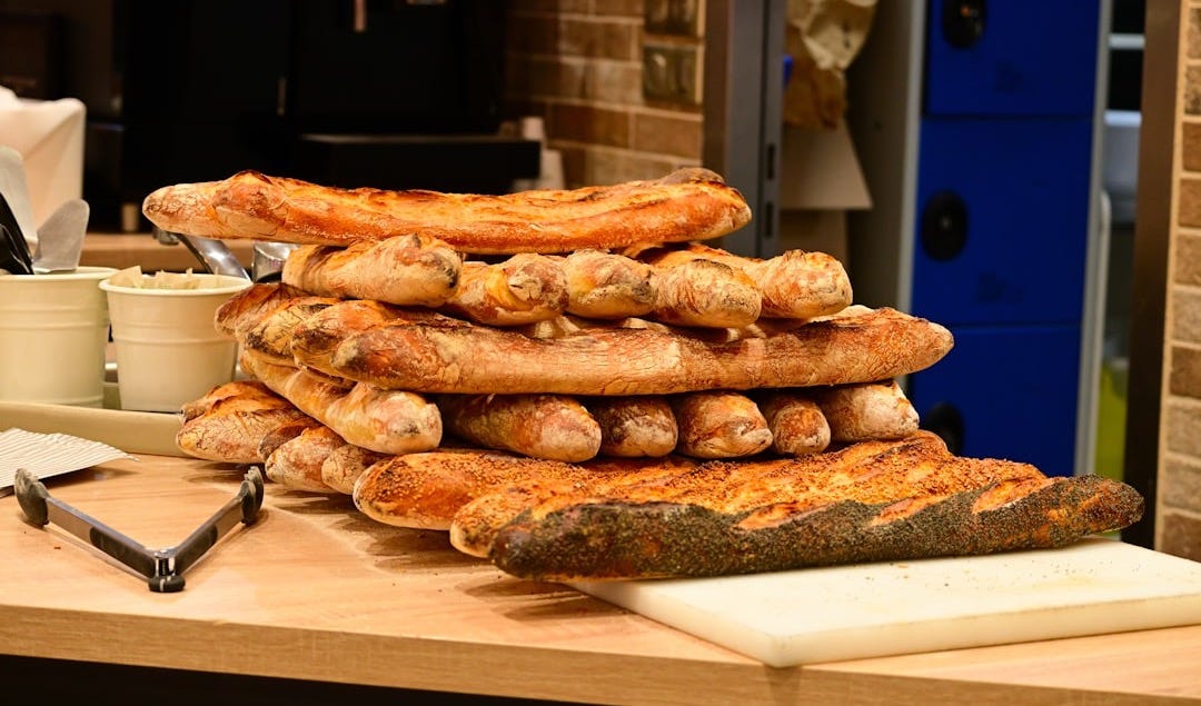 A pile of bread sitting on top of a wooden table