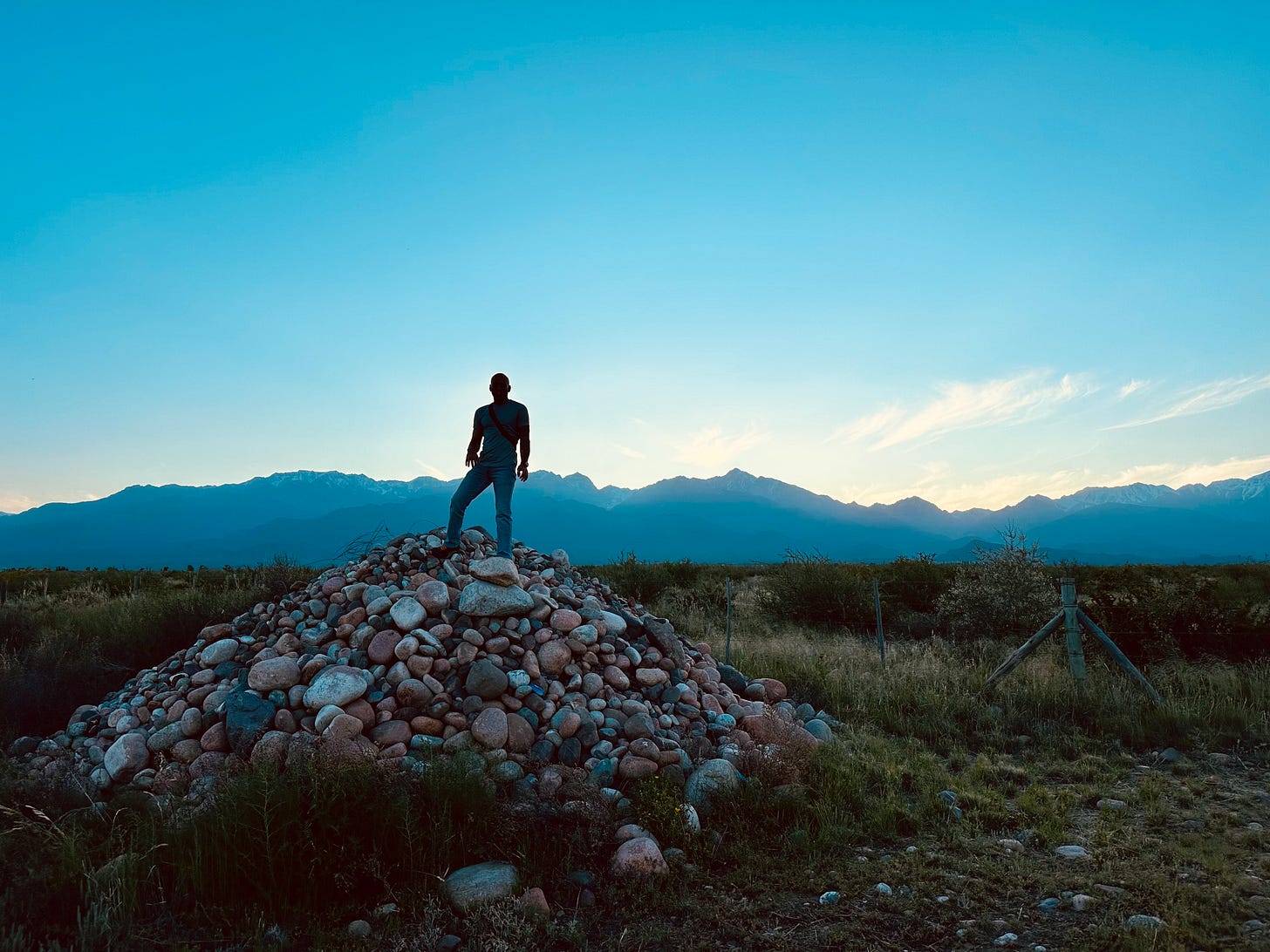 LeVon standing on a pile of rocks in our vineyard
