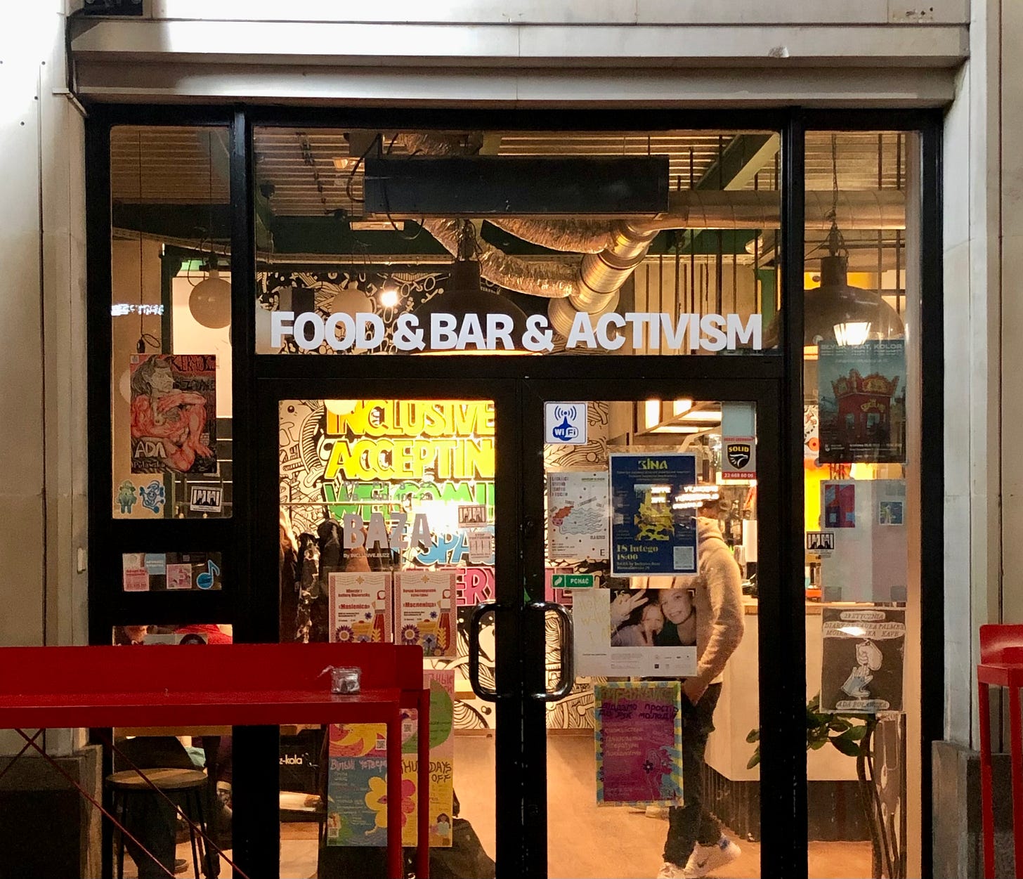 A cafe storefront with the words "food & bar & activism"