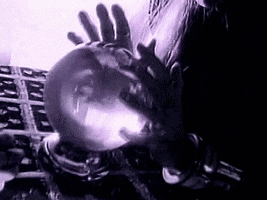 A black and white photo of a person holding a crystal ball