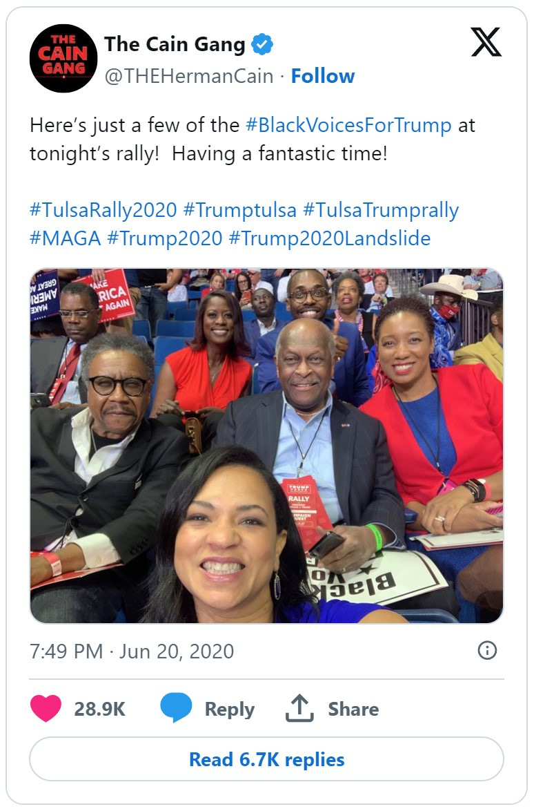 Cain, smiling at a Trump rally