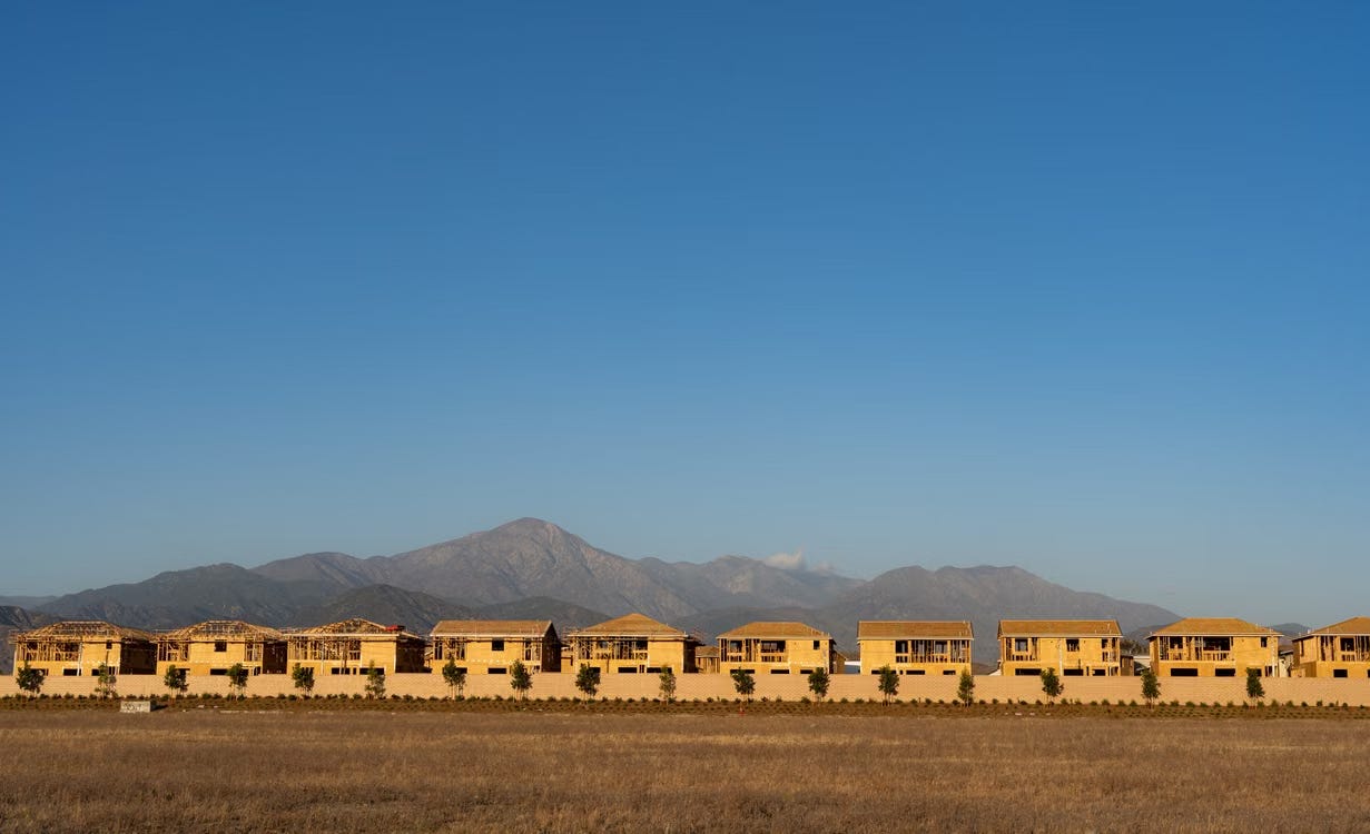 A row of unfinished houses with mountains in the background, Redlands, CA