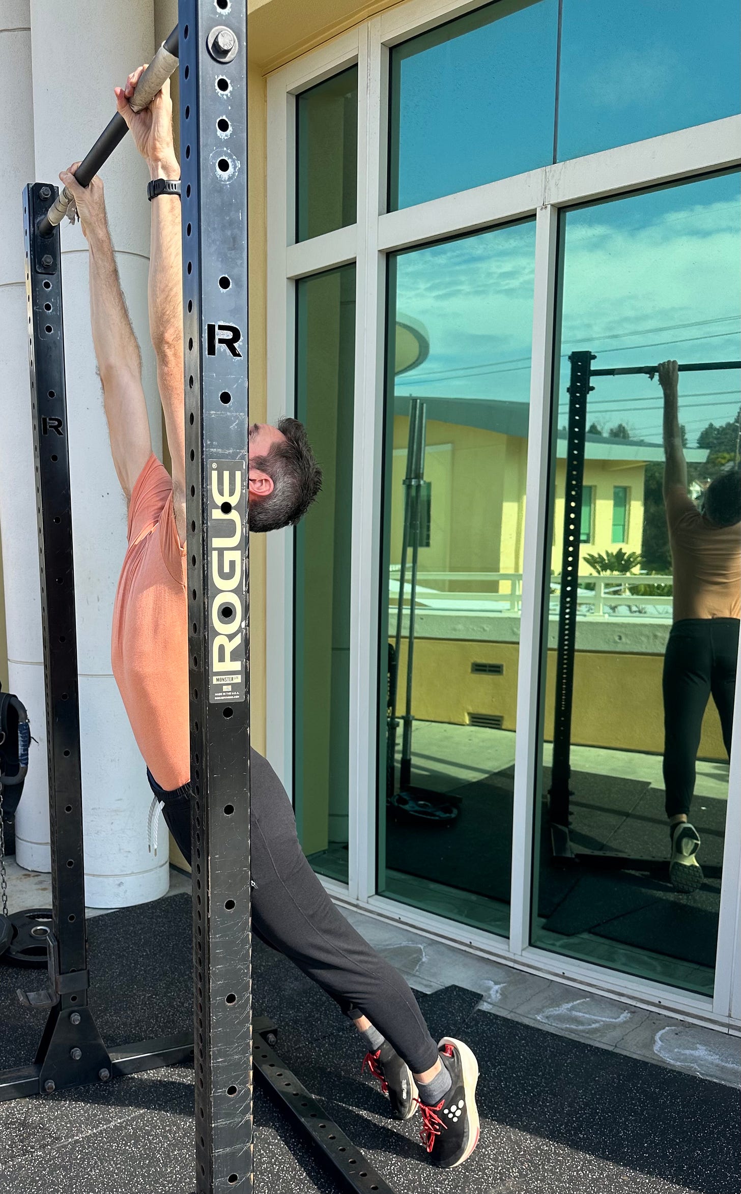 a man hanging from a bar