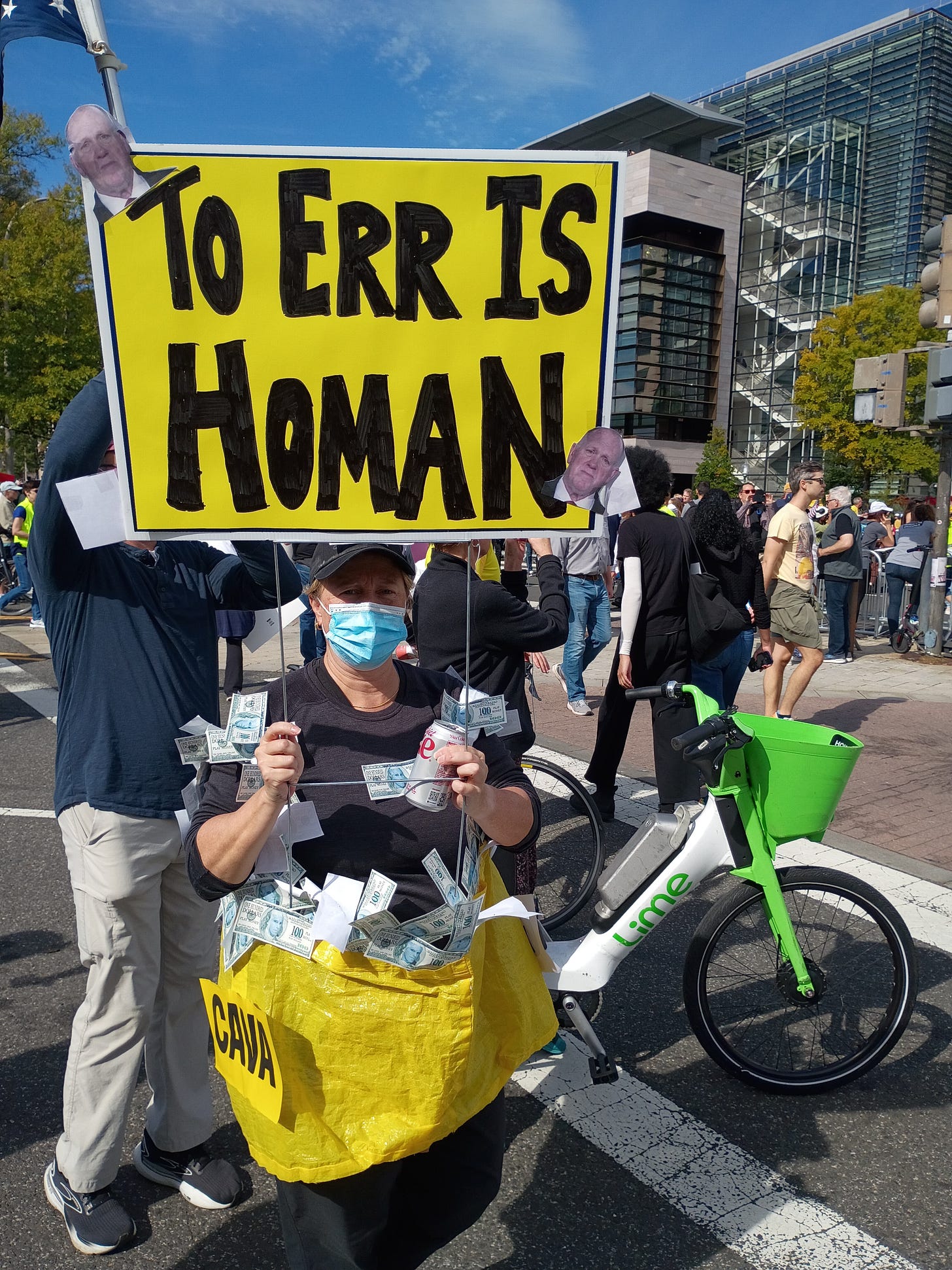 Protest sign reading “To err is Homan"
