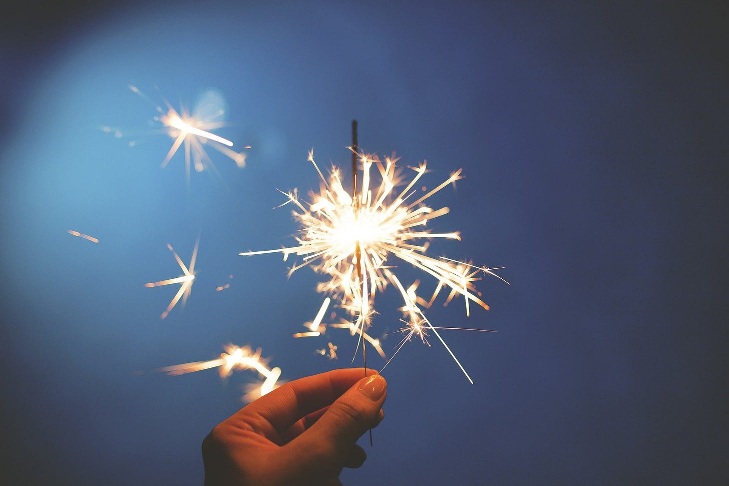 A sparkler : a hand held firework representing celebrations A sparkler : a hand held firework representing celebrations