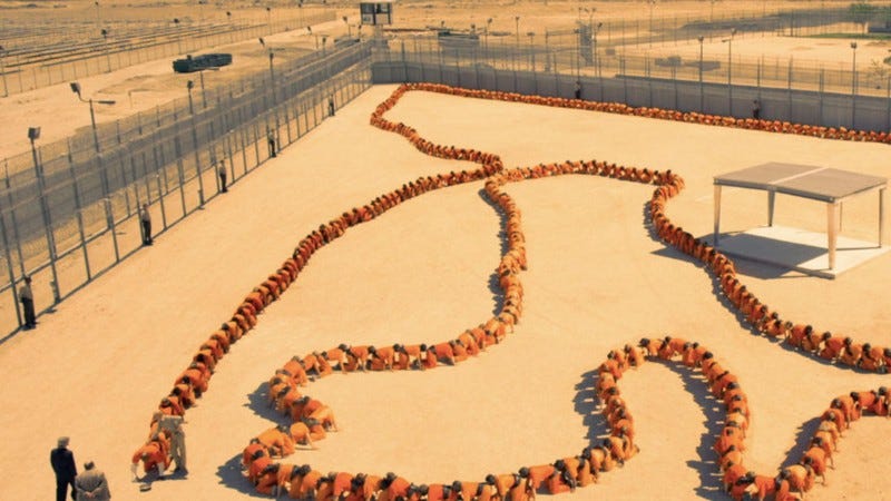 A mass of prisoners forcibly sewn together in a long human centipede chain, representing the extreme and exploitative shock tactics of the third film.