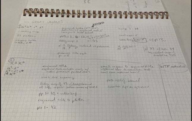 a pile of notebooks and a sheet of graph paper with notes on it in several columns