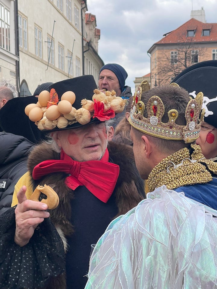 Masopust celebrants in traditional masks and costumes parading through the streets of Prague.