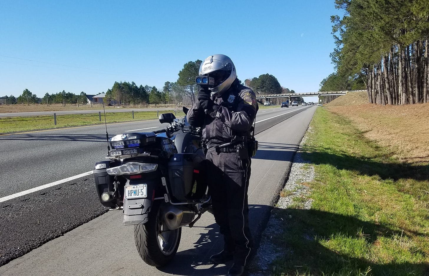 May be an image of 1 person, motorcycle, scooter, road and text