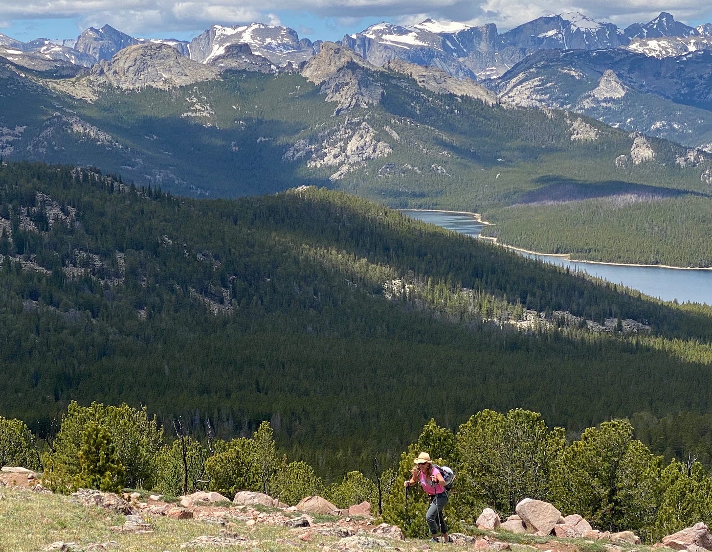 Solo hiker walking through a vast mountain wilderness, capturing the power of stillness and the beauty of being alone with one’s thoughts.
