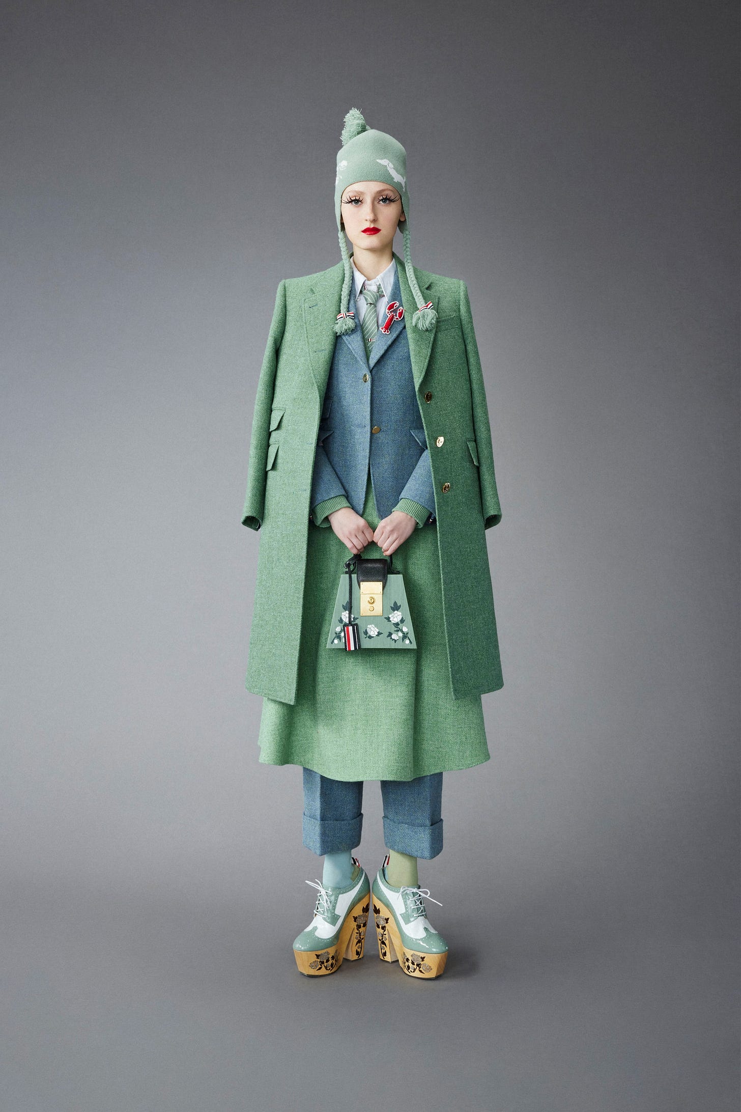 Image may contain Coat Clothing Apparel Overcoat Sleeve Long Sleeve Human and Person