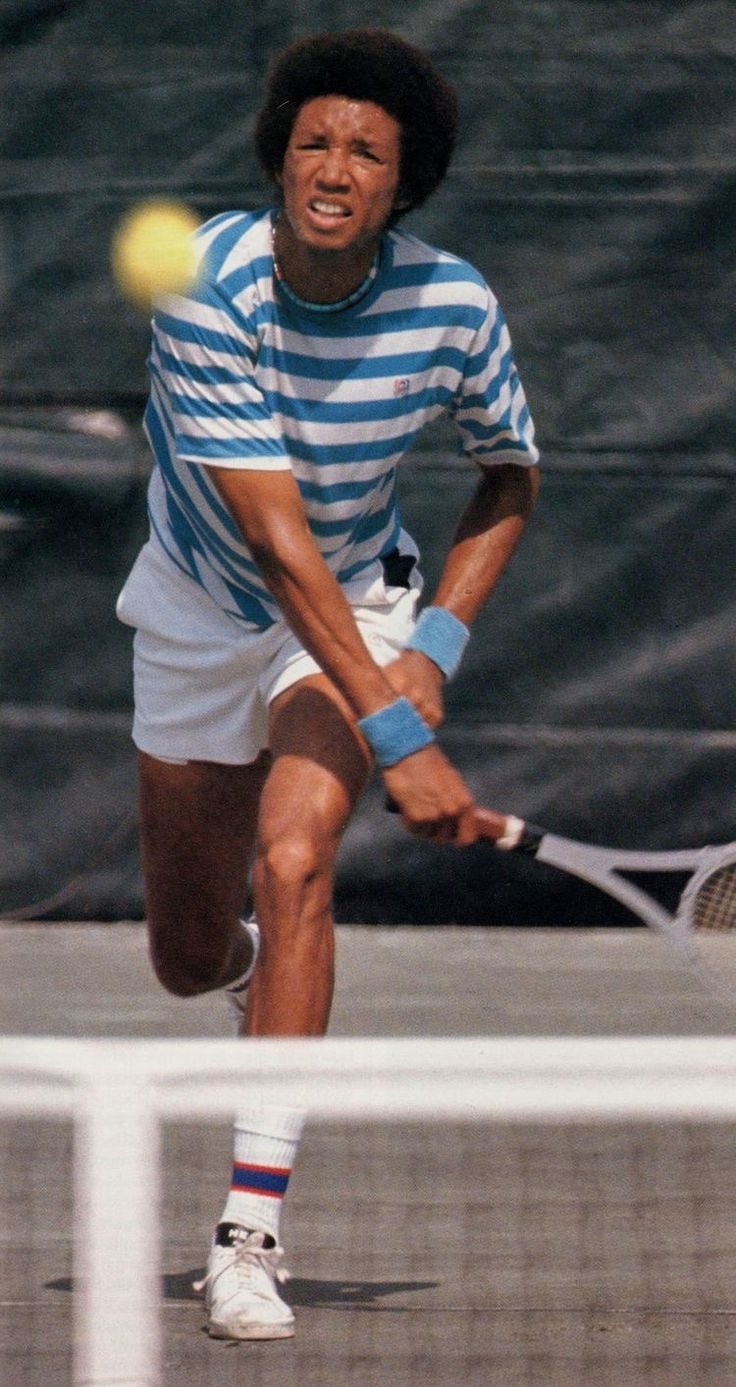 This may contain: a man hitting a tennis ball with a racquet