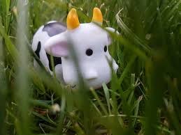 Toy cow is eating grass stock photo ... Toy cow is eating grass stock photo ...