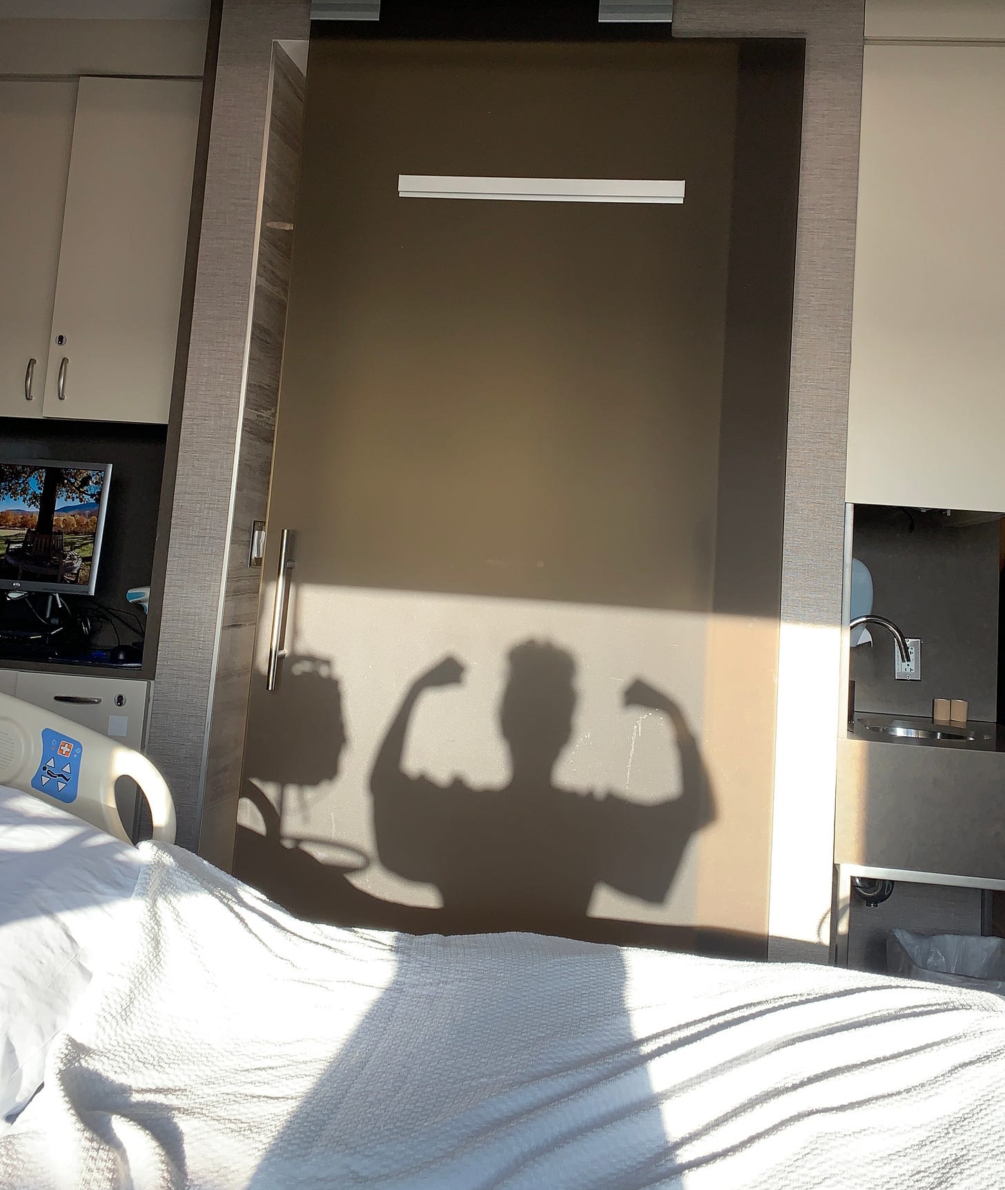 Hospital woman shadow with arms raised as if strong