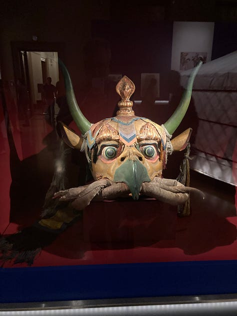 Pictures of a ceramic camel, a pizza, the seal of a General, a Garuda mask, a yurt, a lovely lady looking at a Yama, a map, and a timeline.