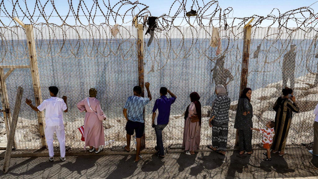 Moroccans gather at Ceuta border, desperate for news of loved ones