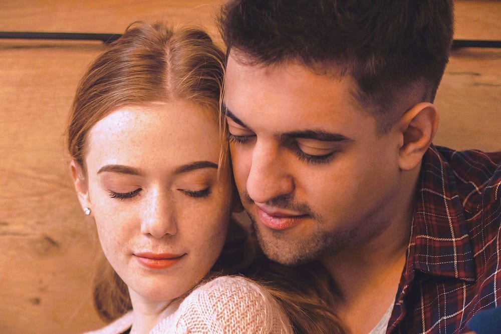 A woman and man sitting close together