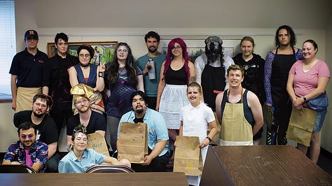 5 Pictures. 1) A group of people taking a selfie with a masked figure. 2) a group photo of people in alien costumes holding grocery bags. 3) Folks in pulpy "ancient egypt" costumes with a mummy chasing them. 4) a group of people in agressively christmasy outfits around a tree. 5) Black and white photo of a group dressed as mobsters.