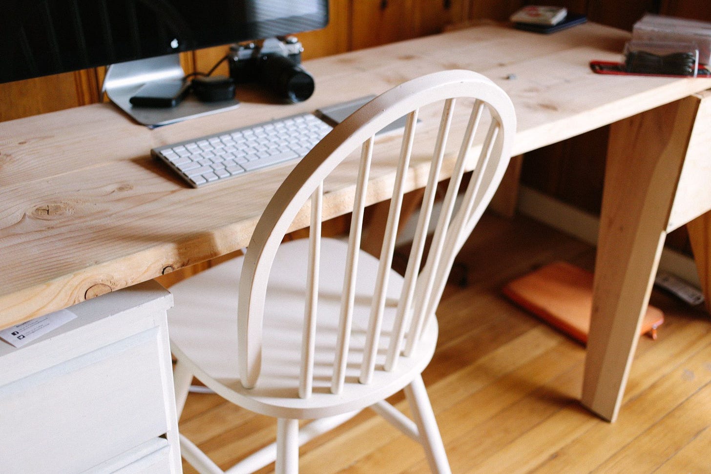 Image of a desk and chair, showing a poor ergonomic setup.