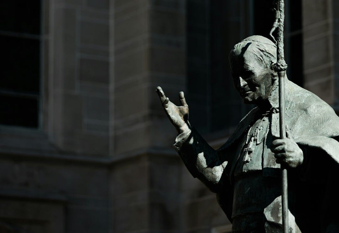 a statue of a pope in the sunlight a statue of a pope in the sunlight