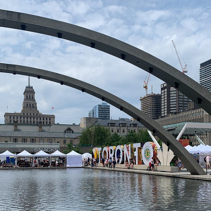 Two images: The TORONTO sign at Nathan Phillips Square with tents around a pool that doubles as a skating rink in the winter. The second image shows the tents with city buildings rising high above in the background.