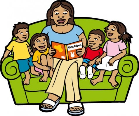 Mum reading on couch with kids lr