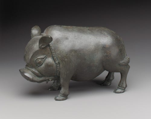 A clay piggy bank in the shape of a wild boar.
