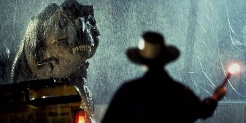Sam Neill's Alan Grant from behind staring at the T-Rex and holding a flare in Jurassic Park (1993) Sam Neill's Alan Grant from behind staring at the T-Rex and holding a flare in Jurassic Park (1993)