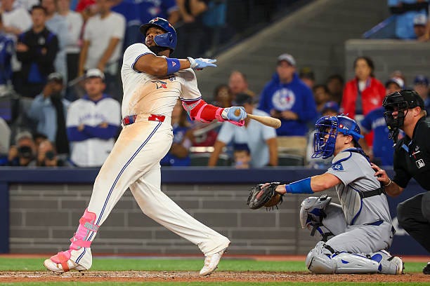 First baseman Vladimir Guerrero Jr. #27 of the Toronto Blue Jays doubles during the 11th inning of game seven of the 2025 World Series against the...