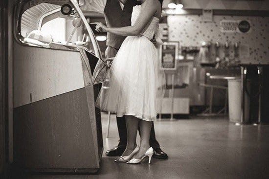 This may contain: two women standing next to each other in front of a toaster oven with the door open