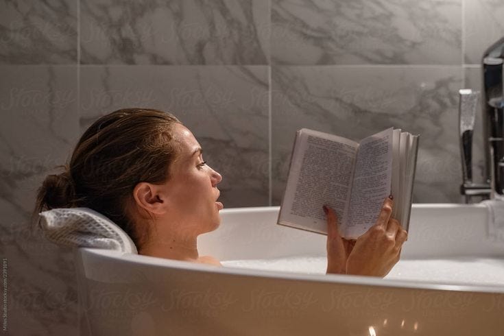 Woman Reading Book In Bath" by Stocksy Contributor "Milles Studio"