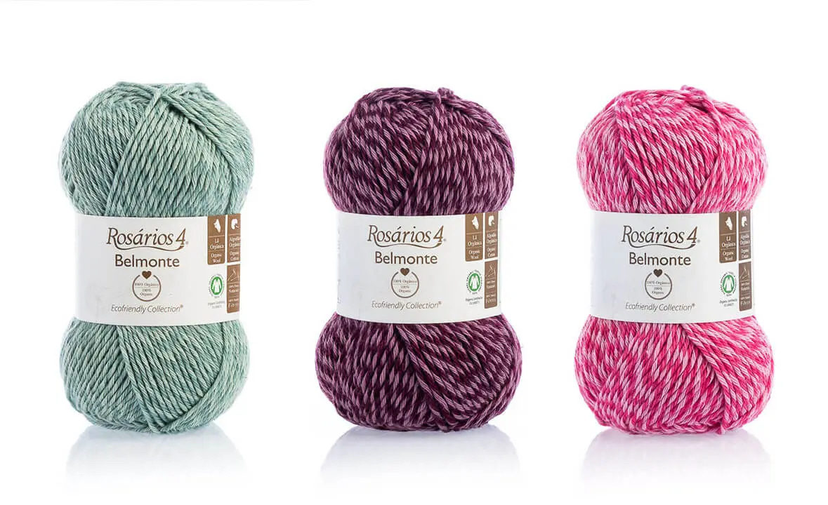 three yarn skeins, from left to right: light green, purple, bright pink