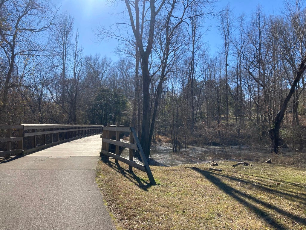 low bridge over the river, into the woods