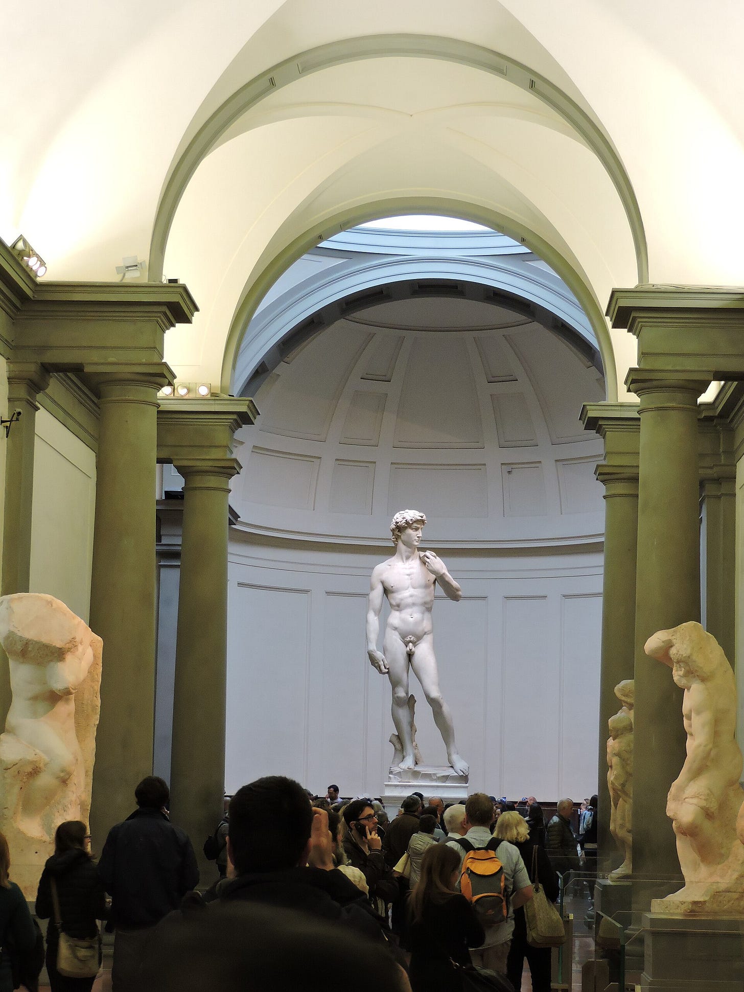 Michelangelo’s white marble David standing nude with a sling over his shoulder. Michelangelo’s white marble David standing nude with a sling over his shoulder.