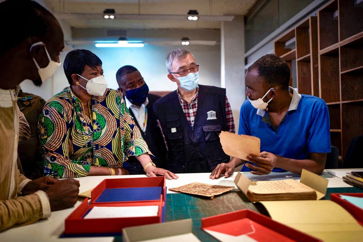UNESCO Deputy Director Xing Qu (2nd R) views some ancient manuscripts on March 31, 2021. (Michele Cattani/AFP via Getty Images) UNESCO Deputy Director Xing Qu (2nd R) views some ancient manuscripts on March 31, 2021. (Michele Cattani/AFP via Getty Images)