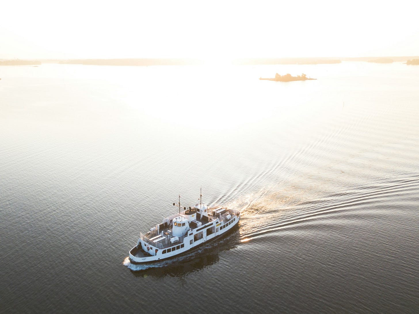 white cruise ship on calm body of water