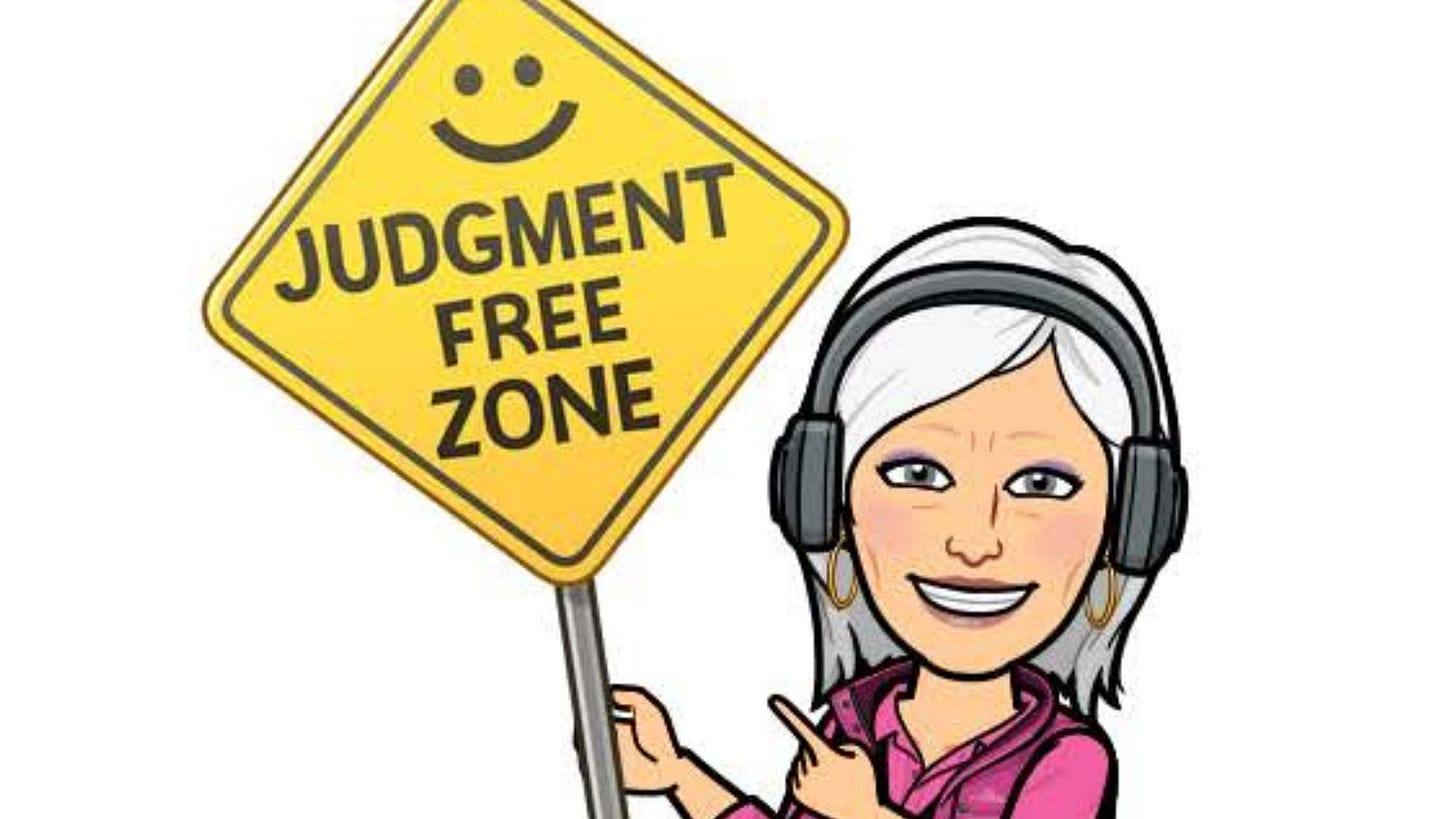 Author’s Bitmoji smiling at the camera with her white hair, headset, hot pink blouse, and vest pointing to a yellow diamond-shaped caution sign that says in black letters, “Judgment Free Zone” with smilely face at the top.