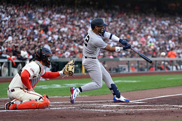 José Caballero of the New York Yankees hits an RBI double against the San Francisco Giants during the second inning on Opening Day at Oracle Park on...
