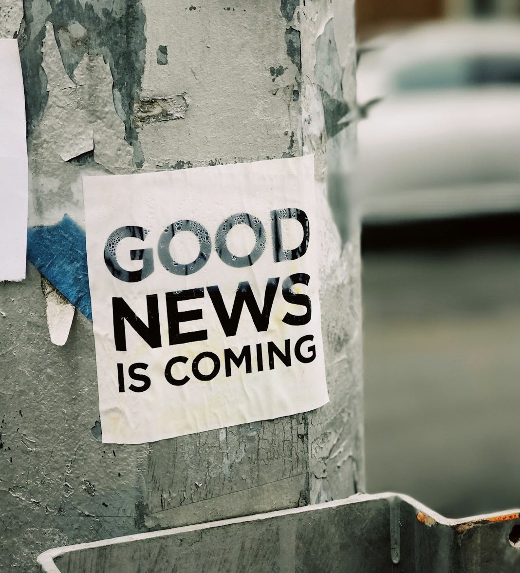 white Good News Is Coming paper on wall
